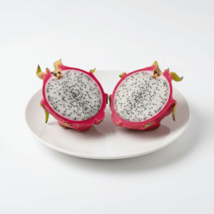 Fresh dragon fruit, whole and sliced, on white background
